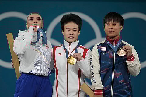 Paris Olympics women's 49kg weightlifting: Michaela Valentina Cambei of Romania, silver, Hou Zhihui of China, gold, and Surodchana Khambao of Thailand, bronze